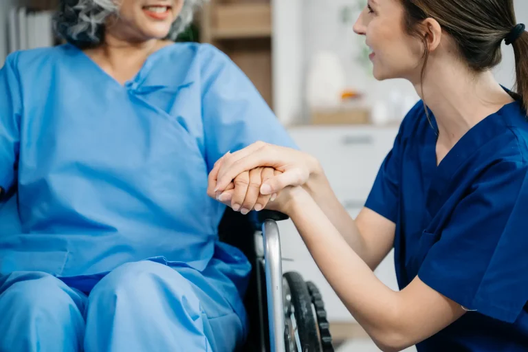Comforting the patient by holding her hand by the caregiver.