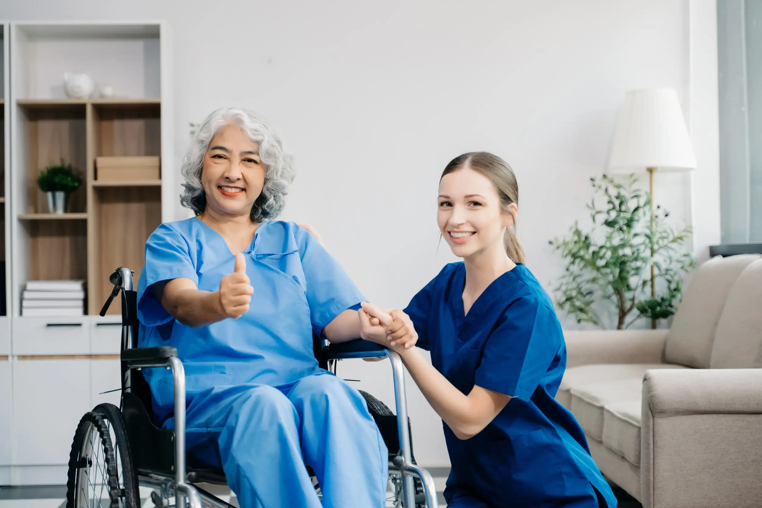 A patient giving a thumbs up to the caregiver.